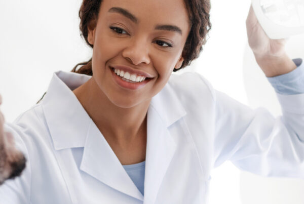 Female dentist talking to male patient.