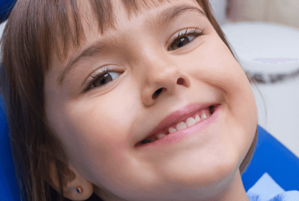 Smiling girl in dental chair.